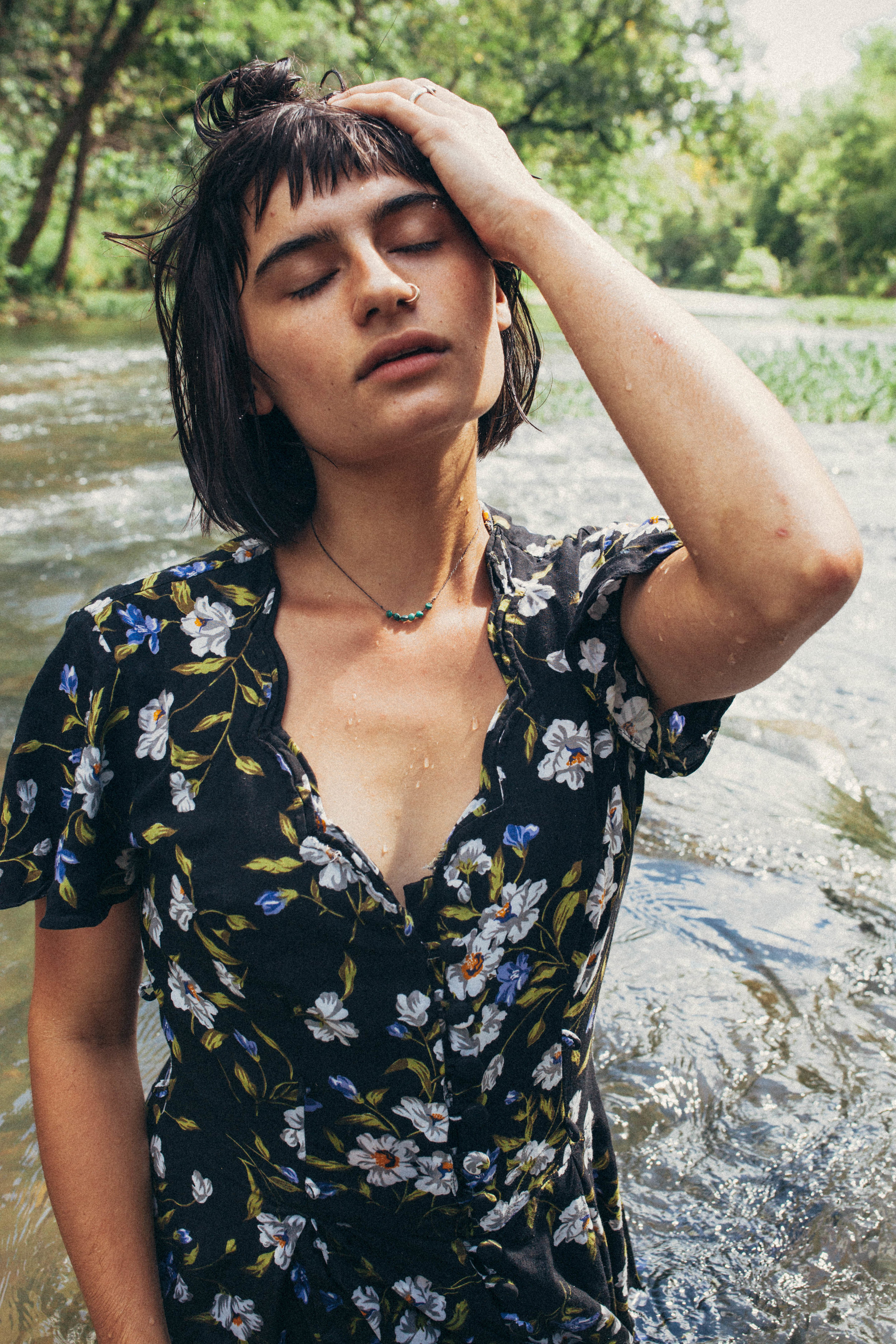 Missouri editorial session. portrait of a dark haired girl in a flowy dress in the river in 