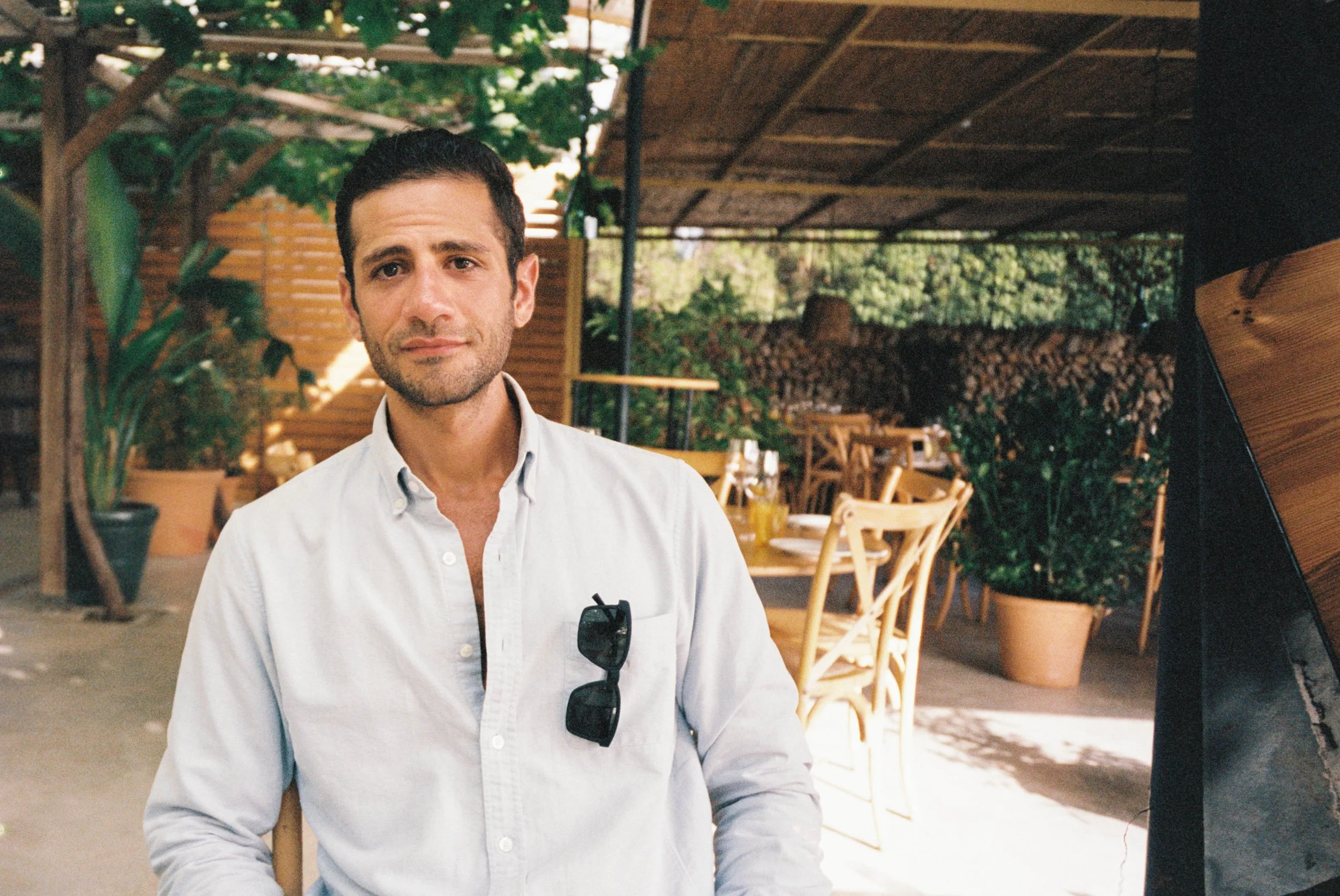 ann-millington-photography-menorca-man-portrait-outdoor-restaurant-pergola-shot-on-film.jpg