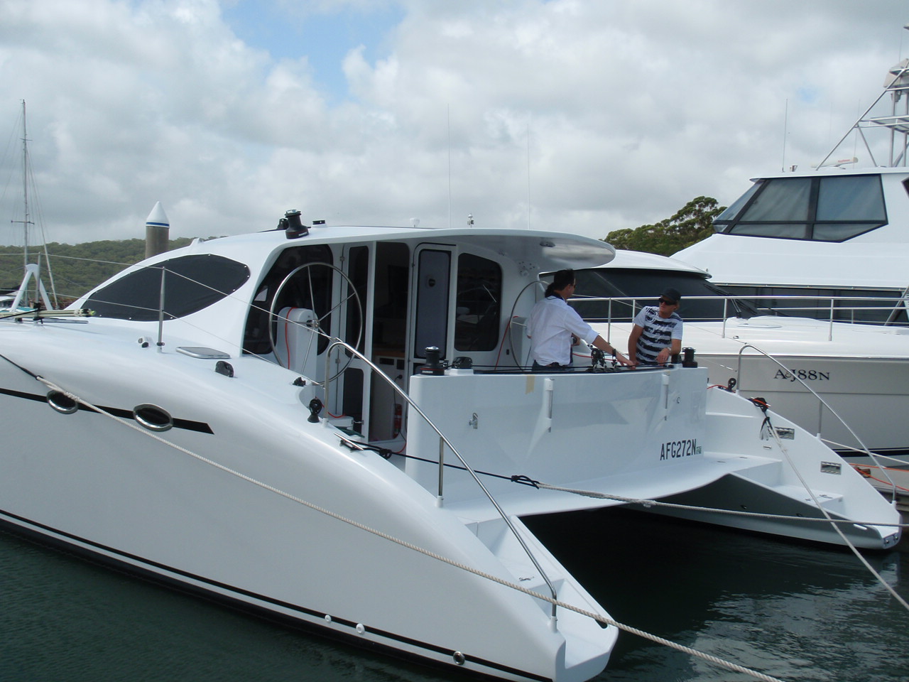 Michael talking boats with Craig and Marina Schionning onboard a newly launched Spirited 380. Port Stephen's NSW. Late 2008.