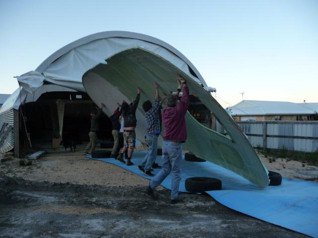 Rolling the cabin roof after completing the underside off the boat. This was the largest laminating job of the build. Hand lay up of the 4m x 10m panel. September 2011.