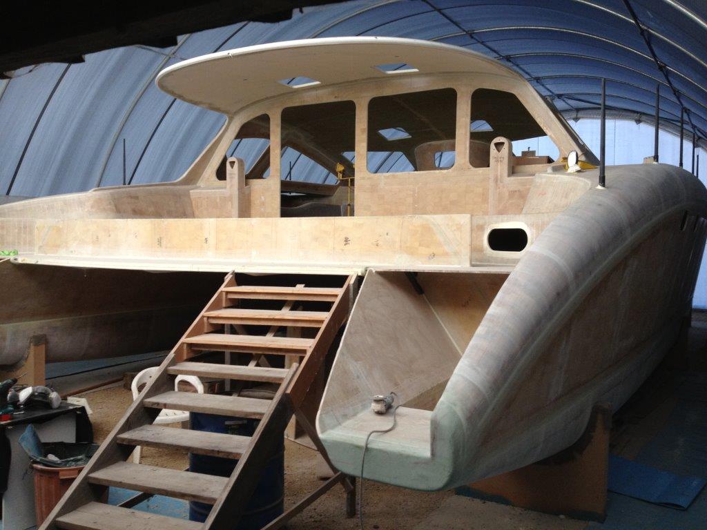 Hull sides on and aft cockpit module off for finishing. June 2012.