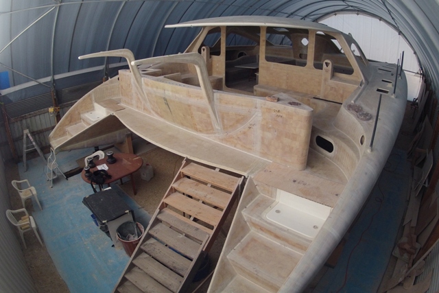 Back steps and engine hatches in, aft cockpit module and davits in place, work commenced on fitting out for the deck hardware. March 2013.
