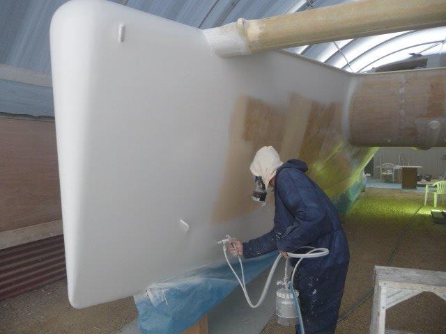 The first "shoot". Russel putting the stbd hull into "sprayable". In 5 weeks Russel and Michael got both hulls sealed, bogged, faired, spray faired and sprayed again with High Build Primer. May 2013.