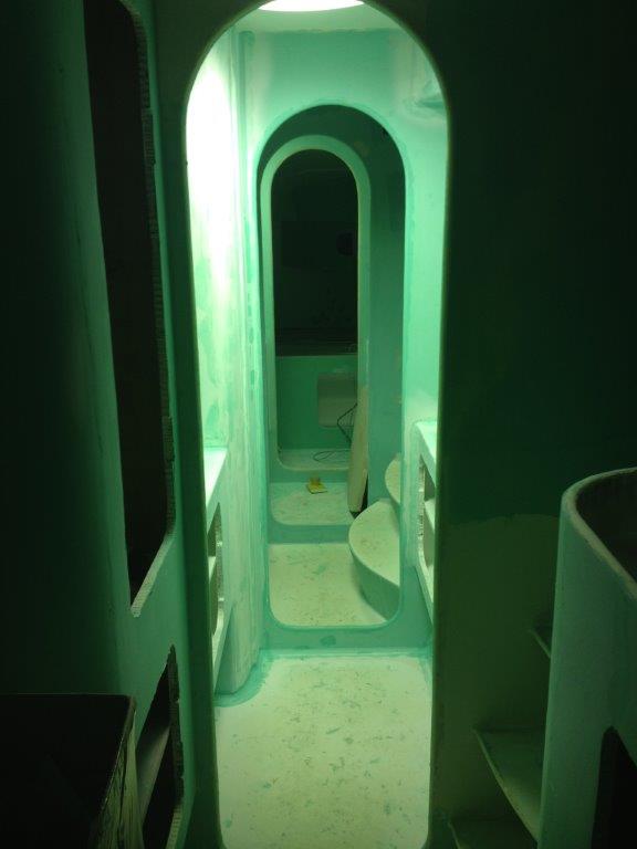 Interior fairing well underway. This is looking aft in the starboard hull. We moved to Jotun products at this stage. The 1:1 pre mixed Jotafair was found to be the most effective in producing a quality finish at a cost effective price however the world of paint systems is a complex one. We found getting consistent advice challenging as everyone has their preferred product and opinion. March 2014.