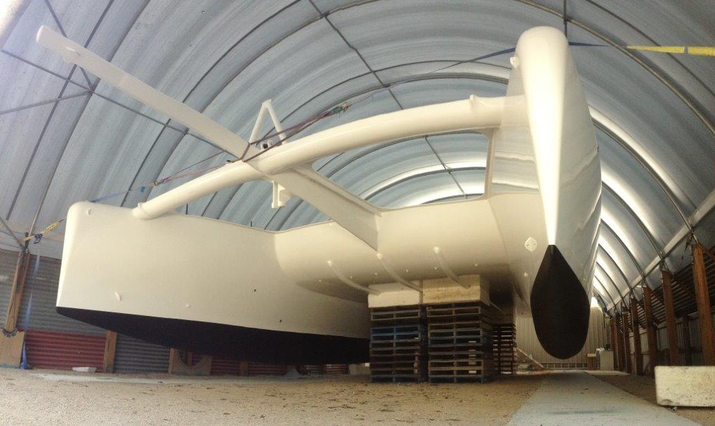 Antifoul on. ROAM is raised out of her cradles and supported under the bridgedeck to allow complete access to the hulls for primer and antifoul application. March 2015.