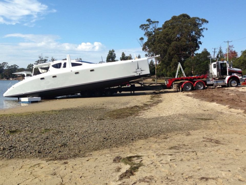 ROAM was launched without crane using Kellara Trasport's "tilt-slide" trailer. The small tides that exist on Tasmania's East Coast meant that the operation had to occur at the peak of the monthly tide cycle. Timing and placement of the boat on the beach was critical. April 2015.