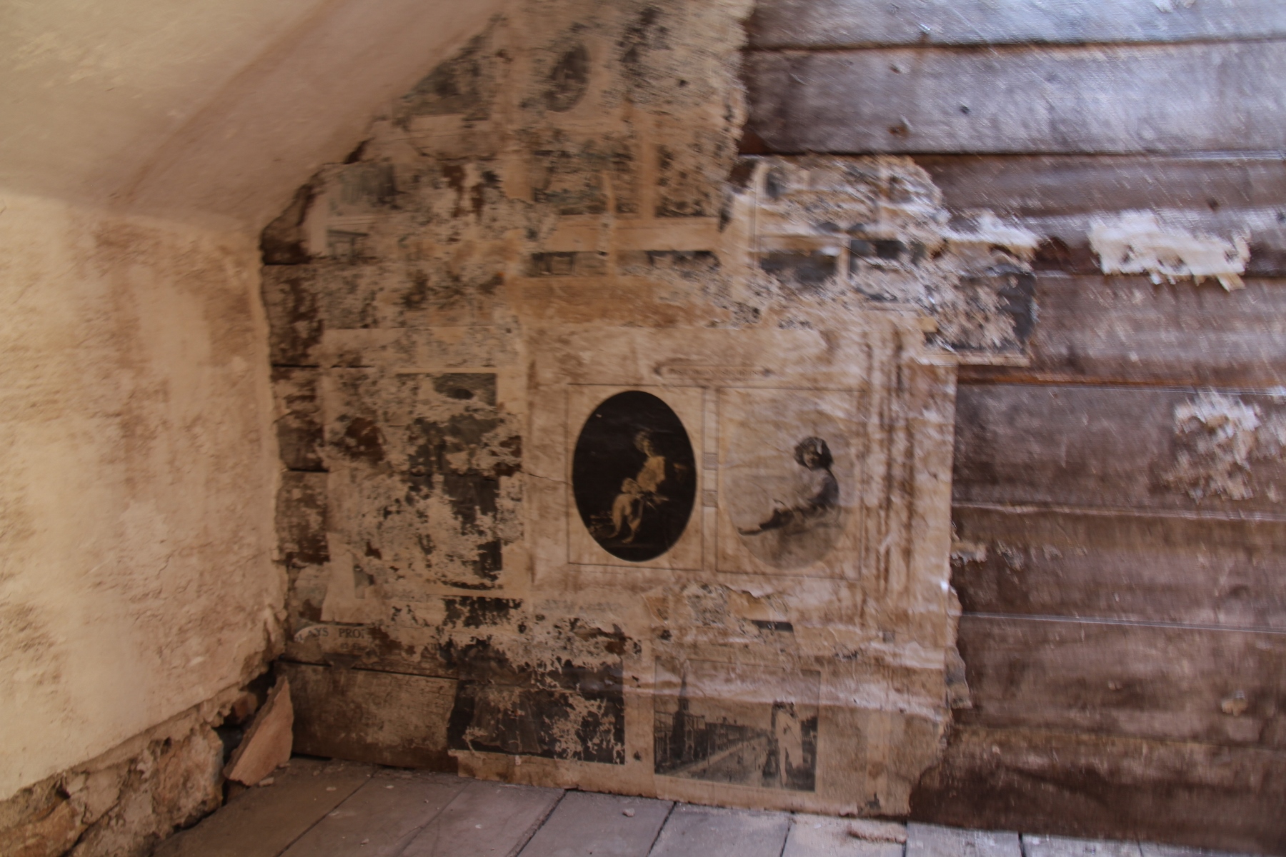 The wall coverings are old news paper clippings.