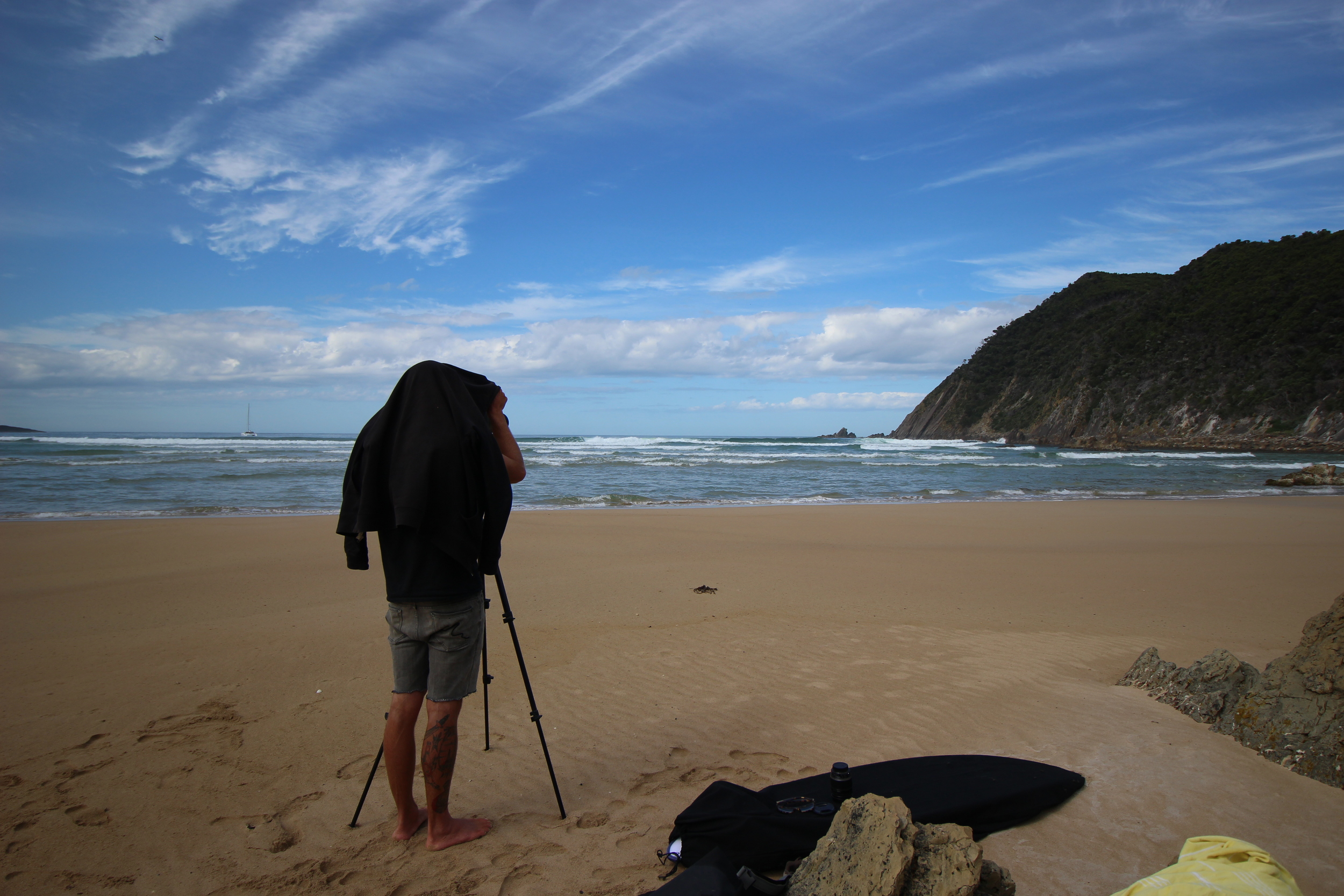 Andy setting up the camera at Surprise Bay to capture some surf footage at this remote break. Roam in the back ground.