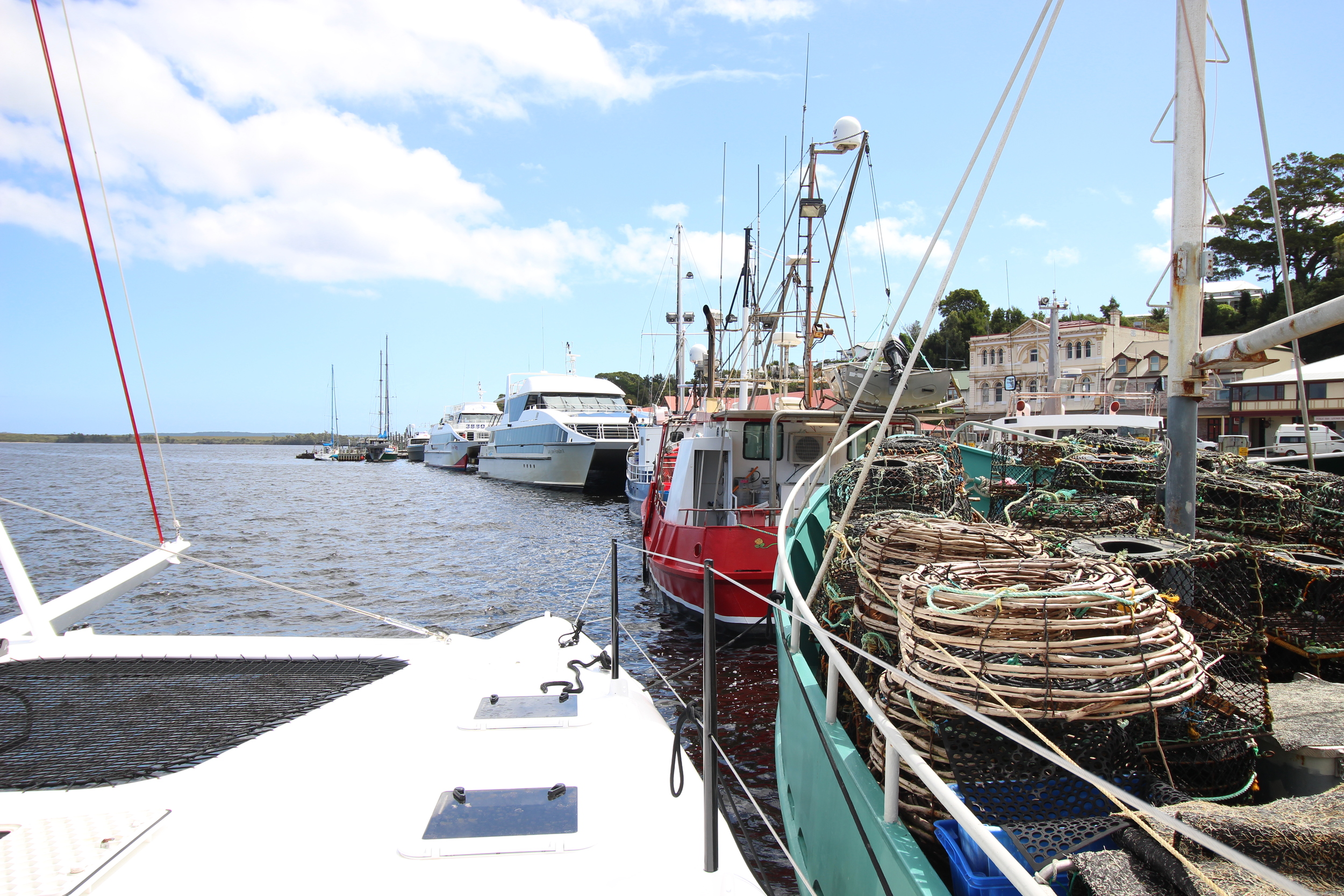 Roam double banked on the fishing wharf in strahan.