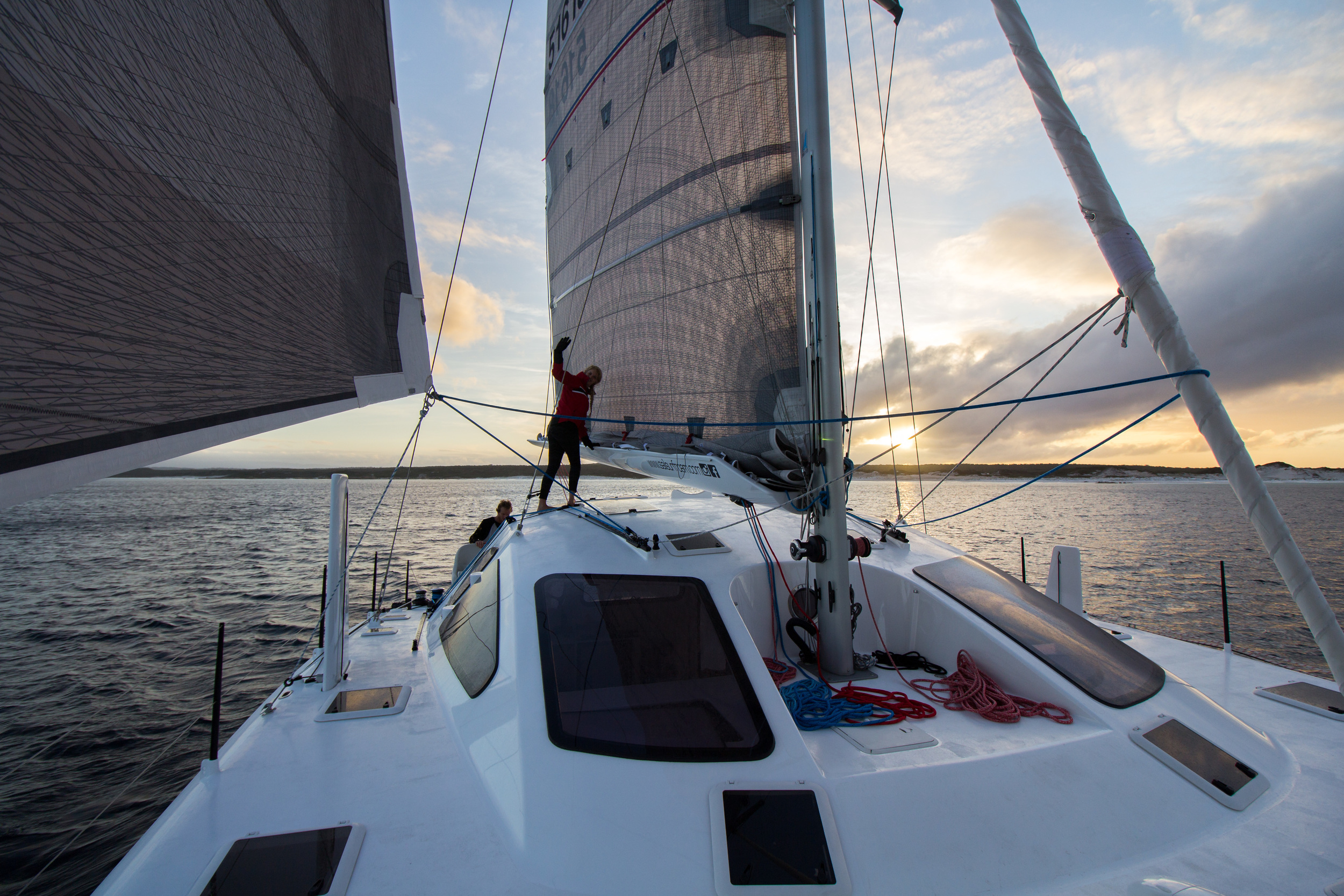 Departing Eddystone, Holly lashing the reef in the mainsail.