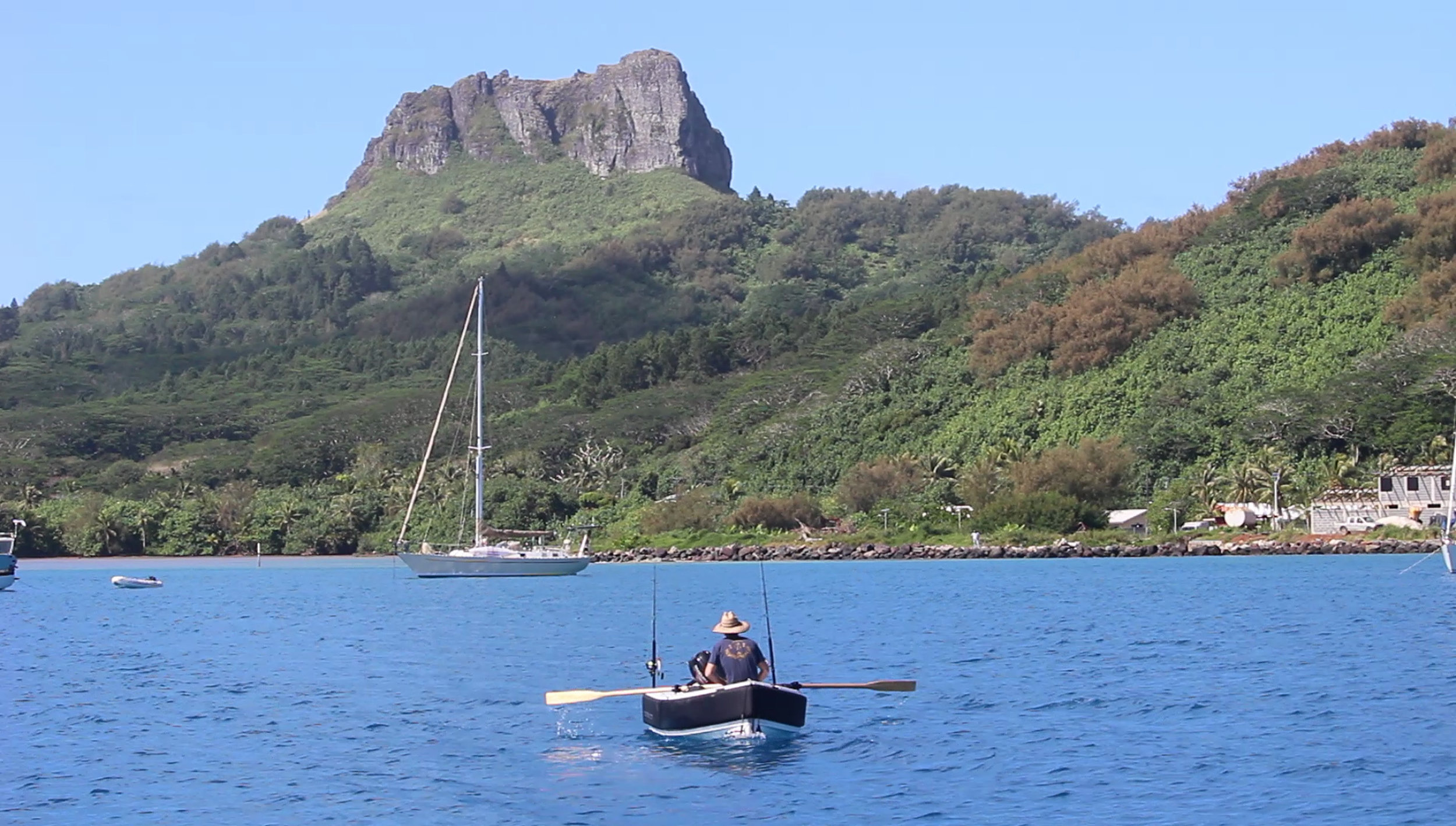 Mick Rowing back to Roam in the main anchorage