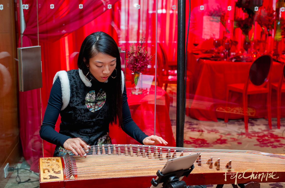 Dr. Claudia Hui plays the Gu Zheng in front of Red Room I. Photo by Krista Fox Photography. 