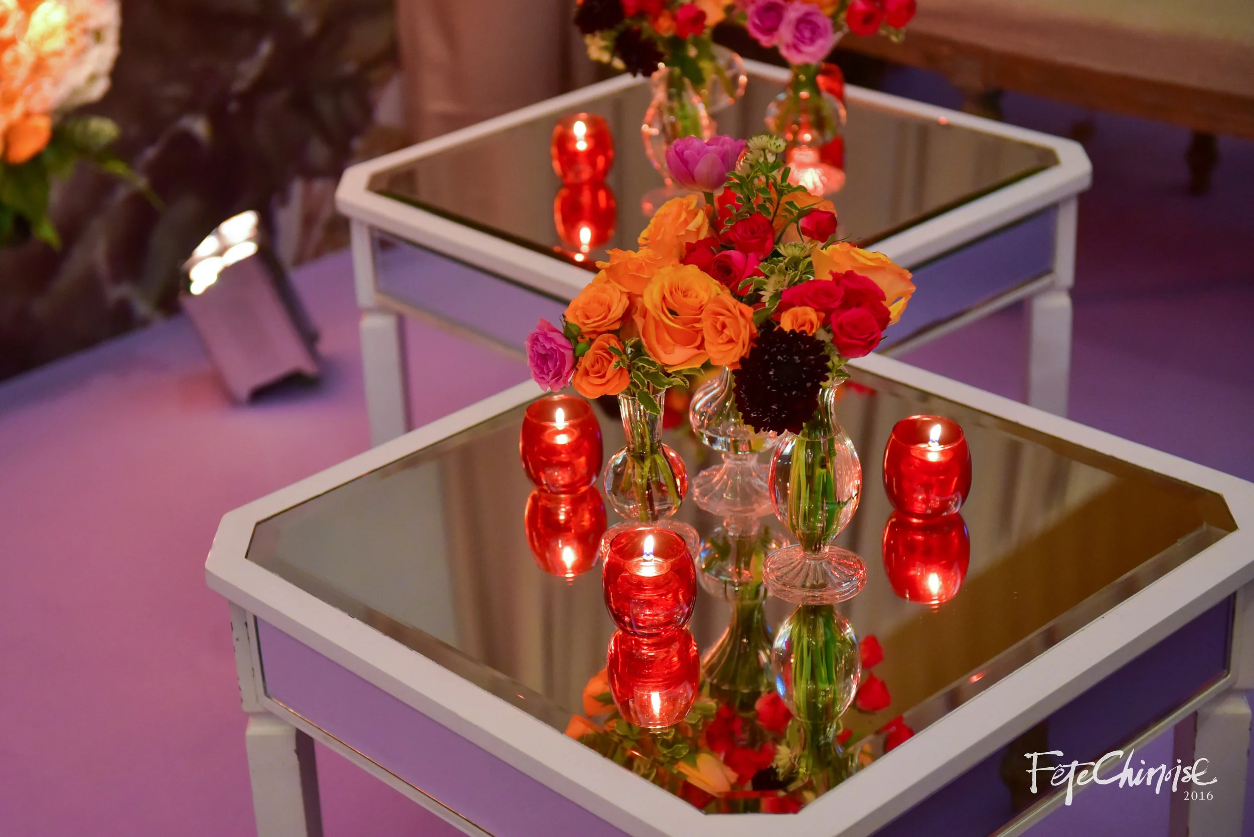 Beautiful highlights in front of the Great Wall of Flowers by Jackie O Events & Contemporary Furniture Rentals. Featuring carpet in purple by Reznick Carpets.