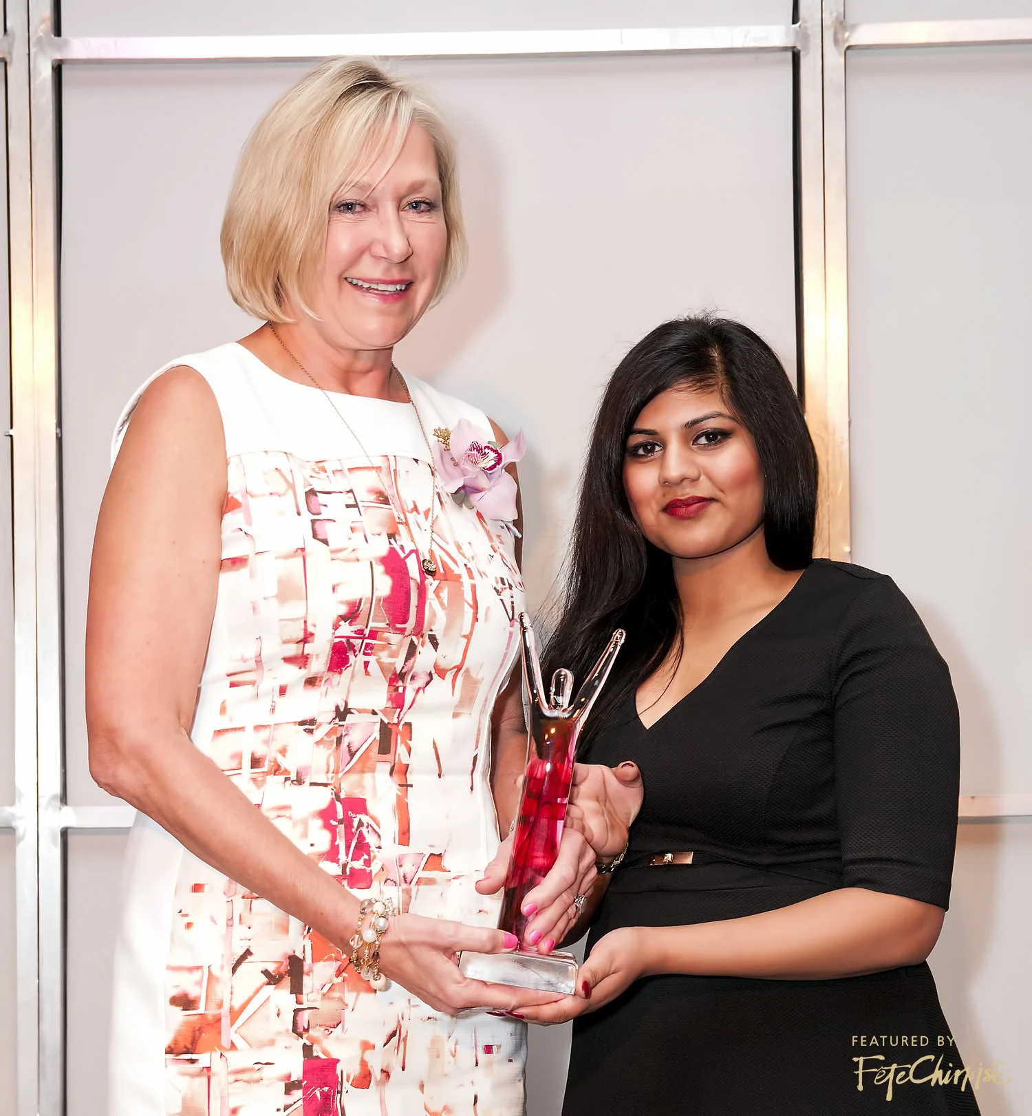 Evi Mustel of the Mustel Group accepts her award from Kasthure Jeyanathan of Audi Downtown Vancouver