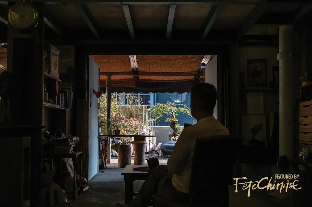 Danny enjoying tea from his studio, viewing outwards towards his urban garden
