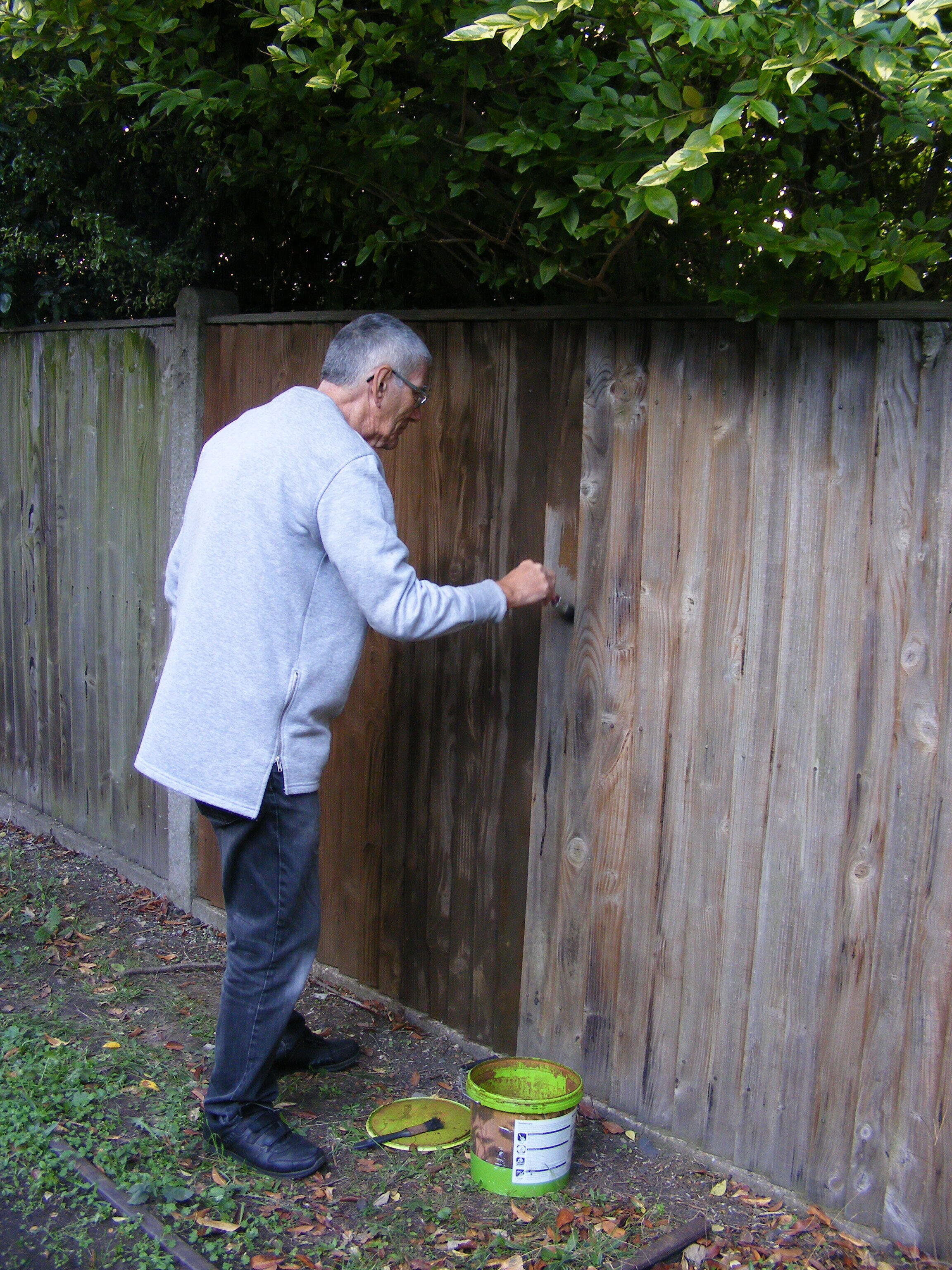 Chris painting the fence.JPG
