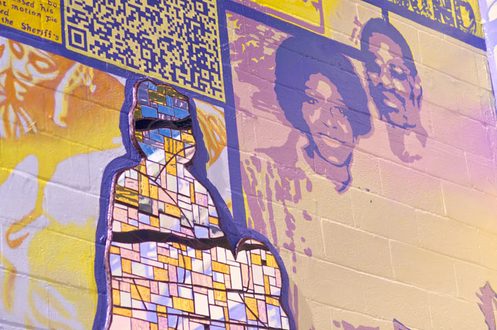  Both sides look and reach toward each other over the center of the design that depicts visiting room life, and its fragmented moments of family interaction.&nbsp; 