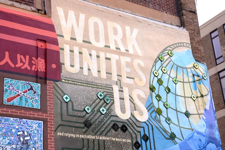 Our overall message “Work Unites Us” continued to ring true." Our artist team was now united in the challenge of translating these ideas, and combining our visual styles into a single piece. 