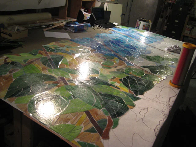  The pieces were laid out one arch at a time. The table was built for this specific project so I was able to devise a way to work with no seams whatsoever in the glass.&nbsp; 