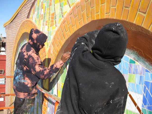  My assistants, Khalil and Koran helped to clean off and buff the glass surface and paint some reflective colors in the archway.&nbsp; 