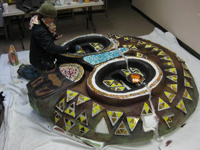  The group quickly took to making patterns with the gold mirror, and using various marbles and beads to decorate the eyes and mouthpiece 