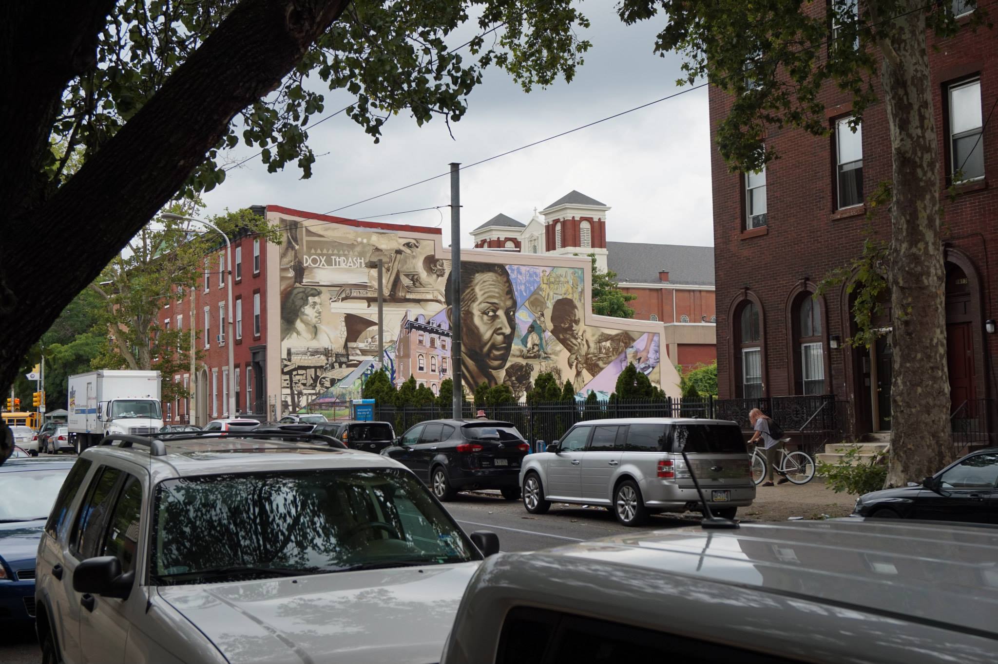 My favorite spot to see the mural, just under the tree branches in front of the Hospital