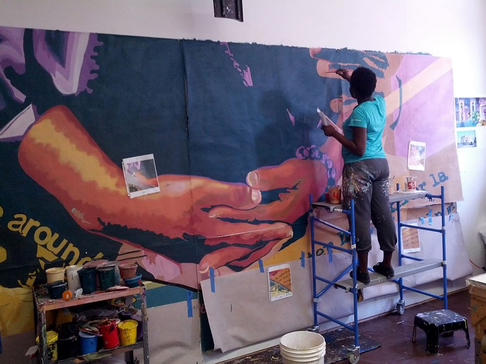 Briana, touching up panels after a paint day. 