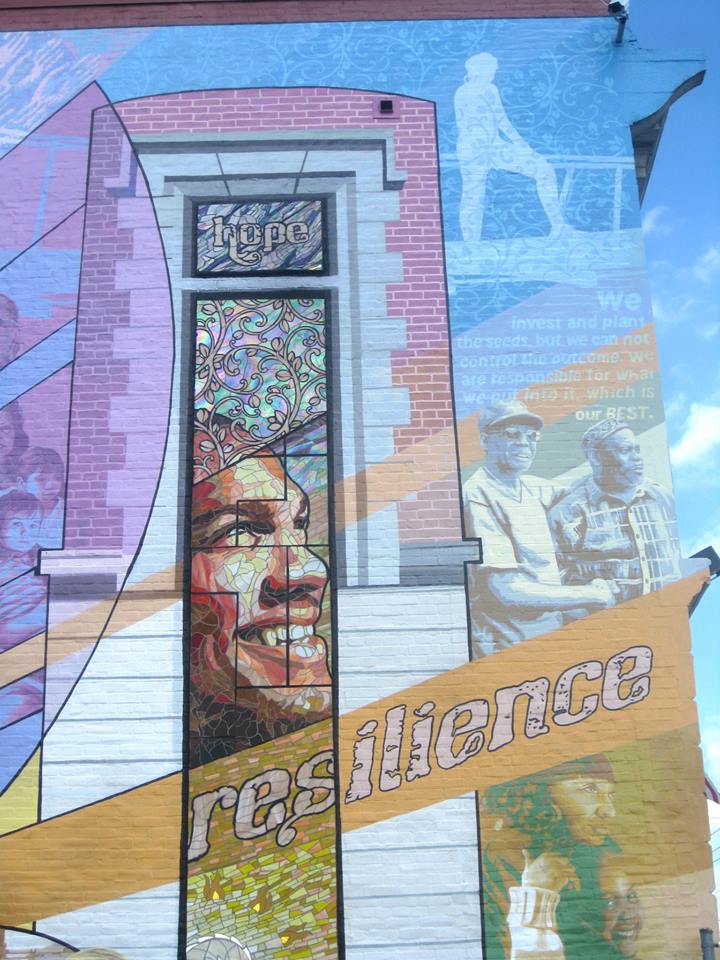 The rightmost window features a portrait of "Julian" a young man who was a success story in the foster care system. He trained and became a professional boxer as an adult, a serendipitous coincidence as the mural faces the site of Joe Frazier's famo
