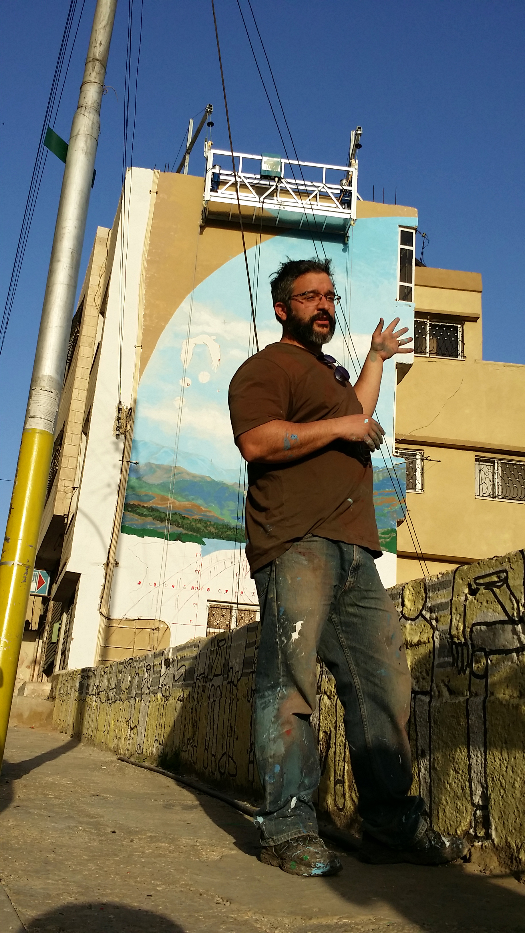 Taking a break to be interviewed in front of my mural. 