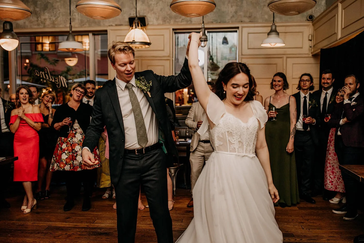 Bride and groom dancing during a private wedding celebration with guests