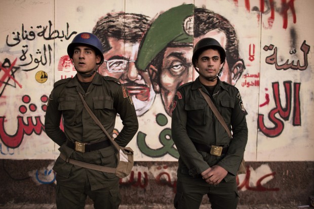Image: A December 11, 2012 photo shows Egyptian soldiers stand in front of a graffiti on the walls of the Presidential Palace in Cairo. (MARCO LONGARI/AFP/Getty Images) Recently, while attending a conference in New York focused on art and so