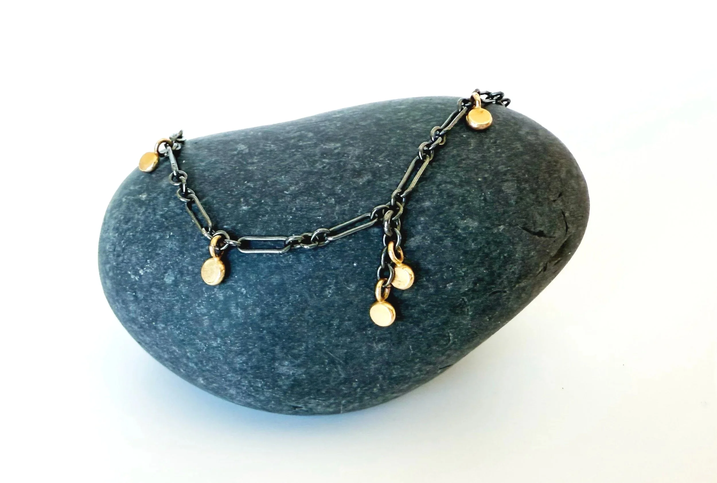 blackened silver chain with gold accent dangles