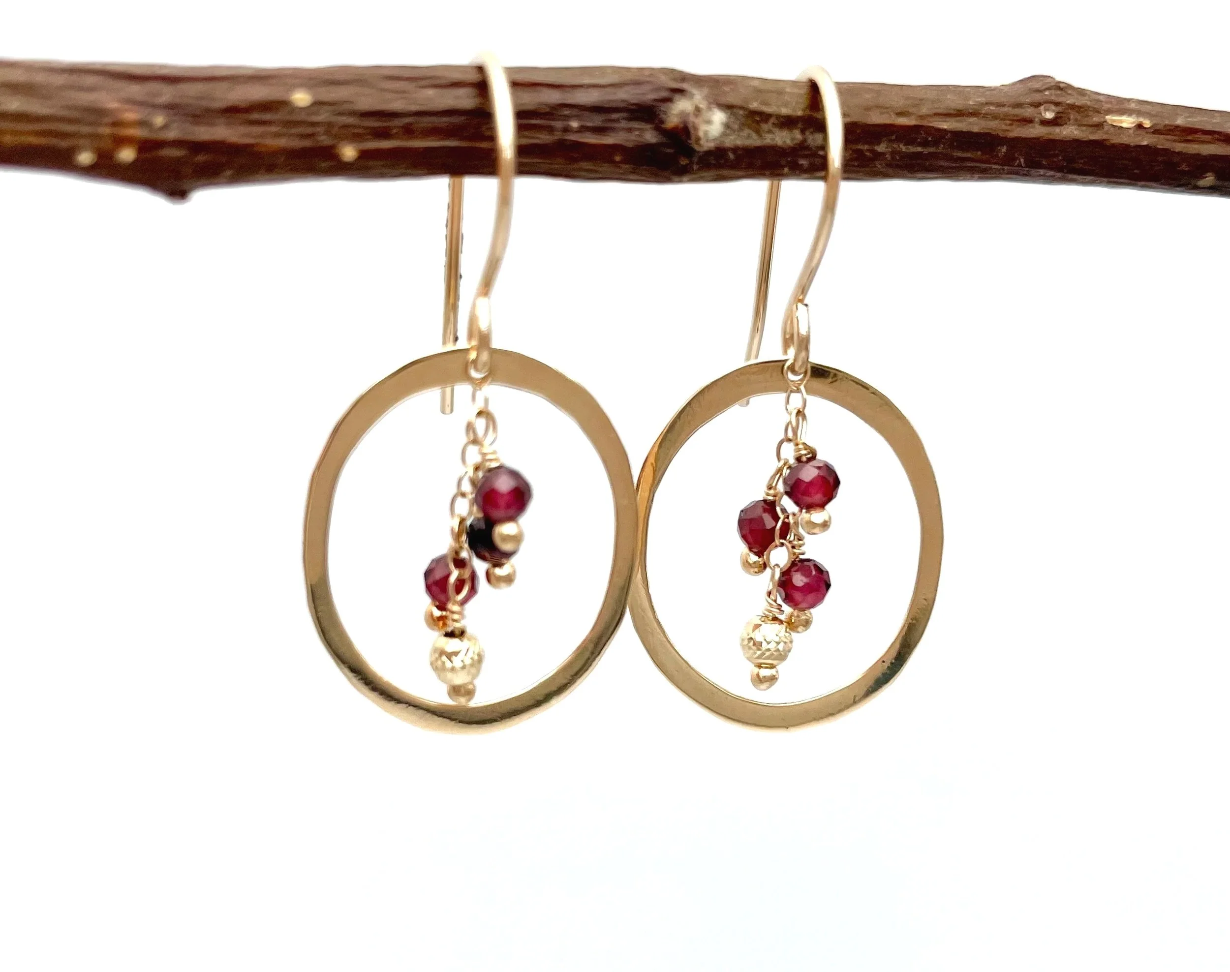 14k gold large hoop earrings with garnet gemstones