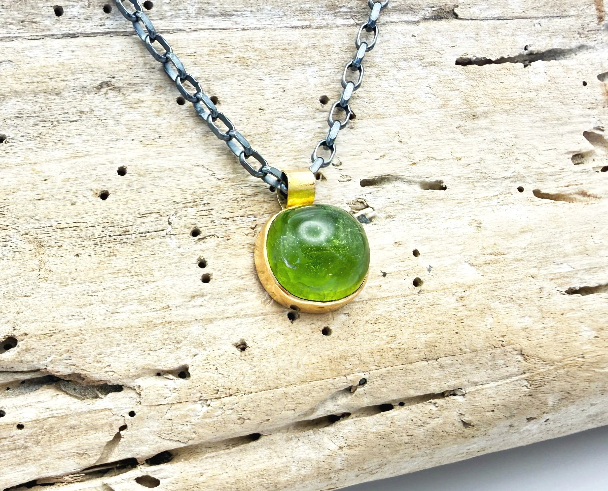 large gold peridot pendant with silver chain