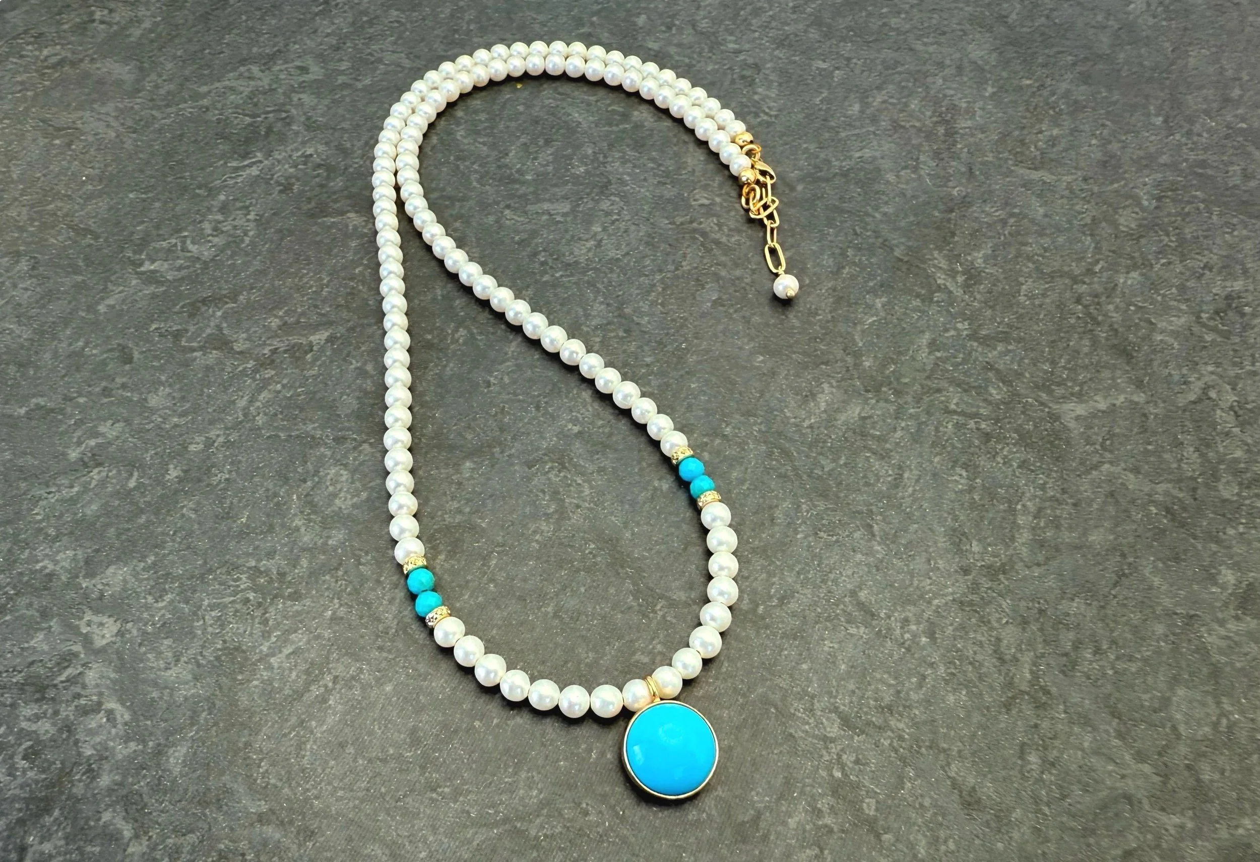 blue arizona turquoise pendant in 14k gold with white pearl strand
