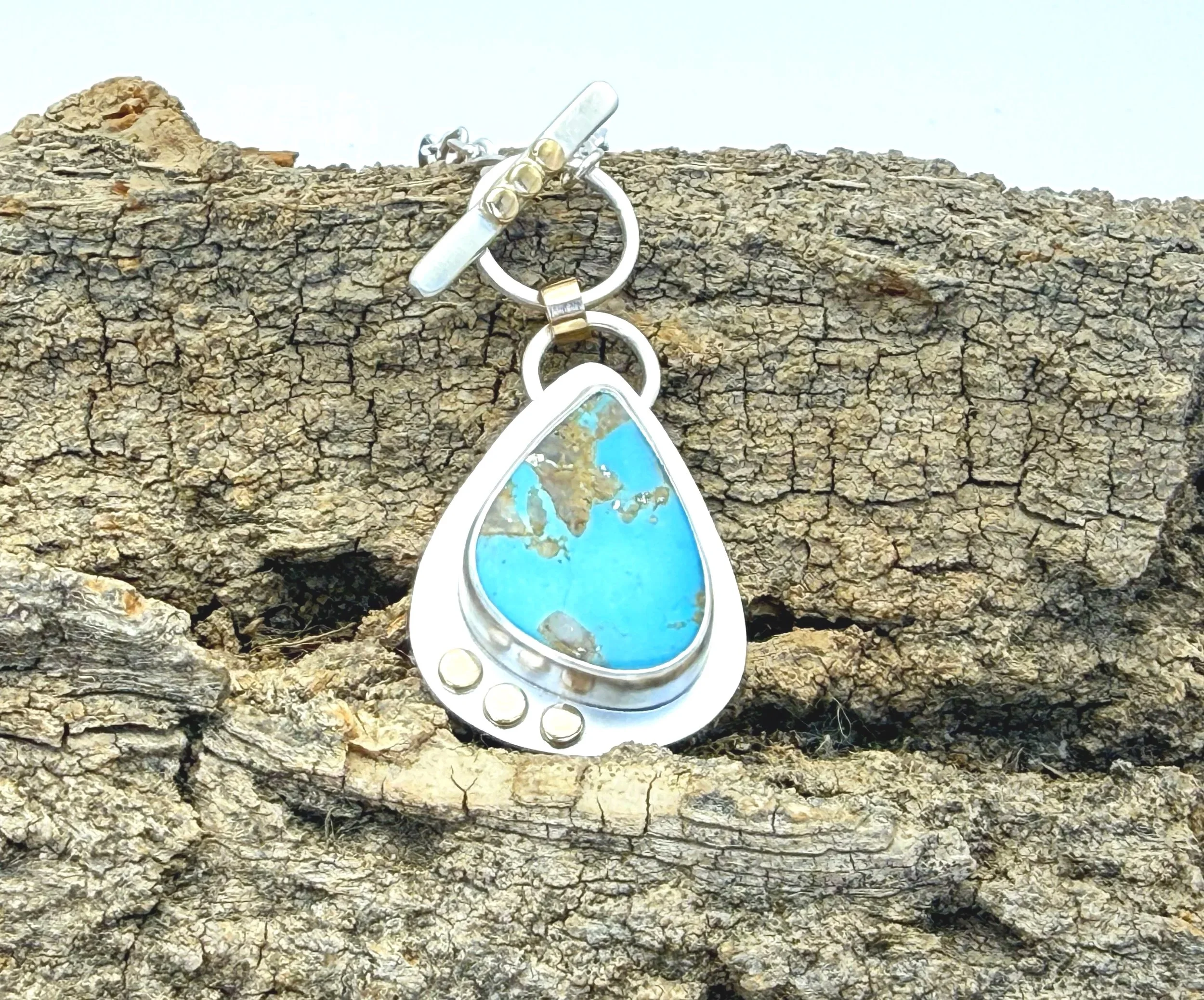 Blue Gem turquoise pendant with toggle clasp on weathered stone