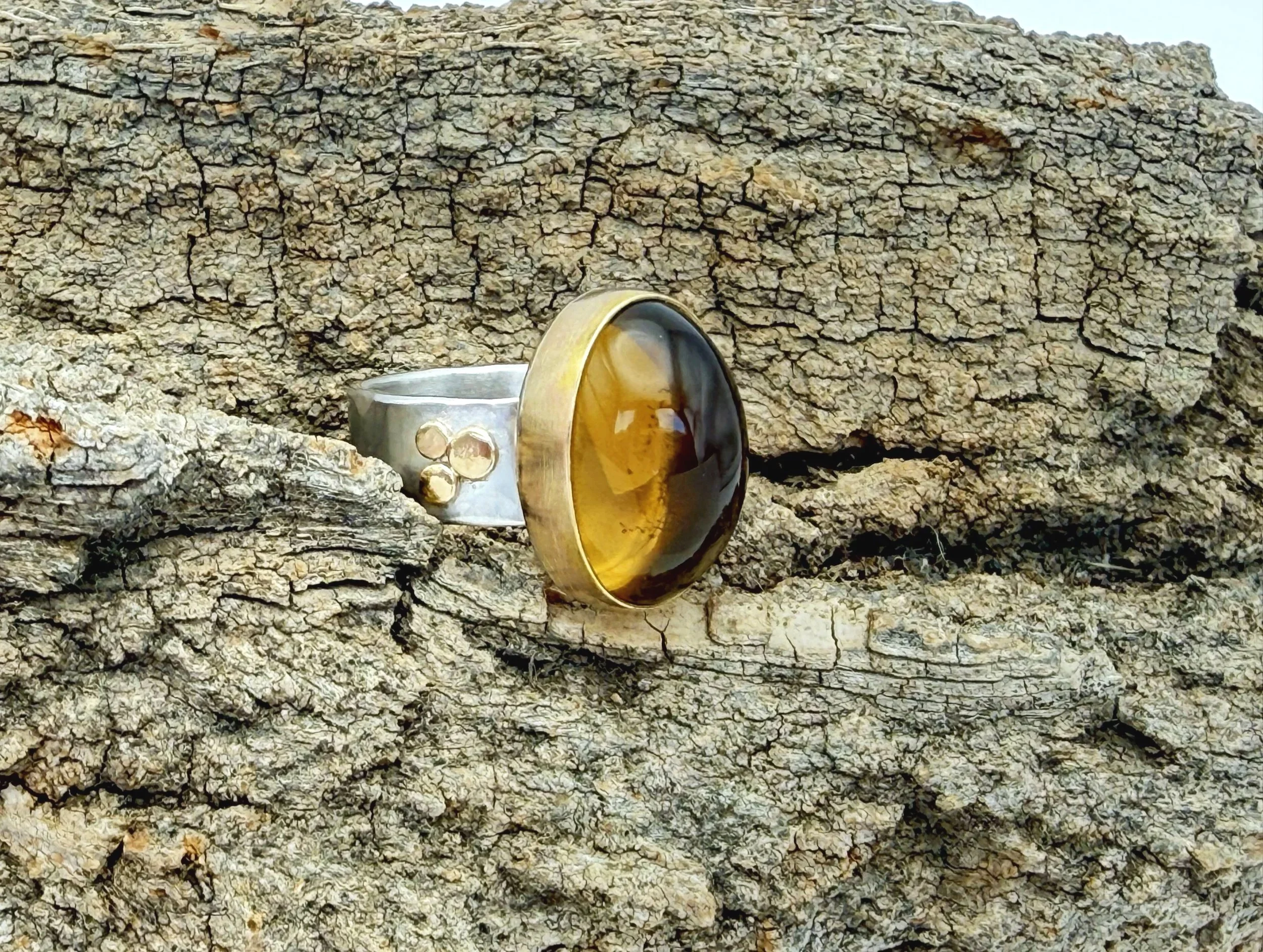 Oval citrine ring on weathered stone