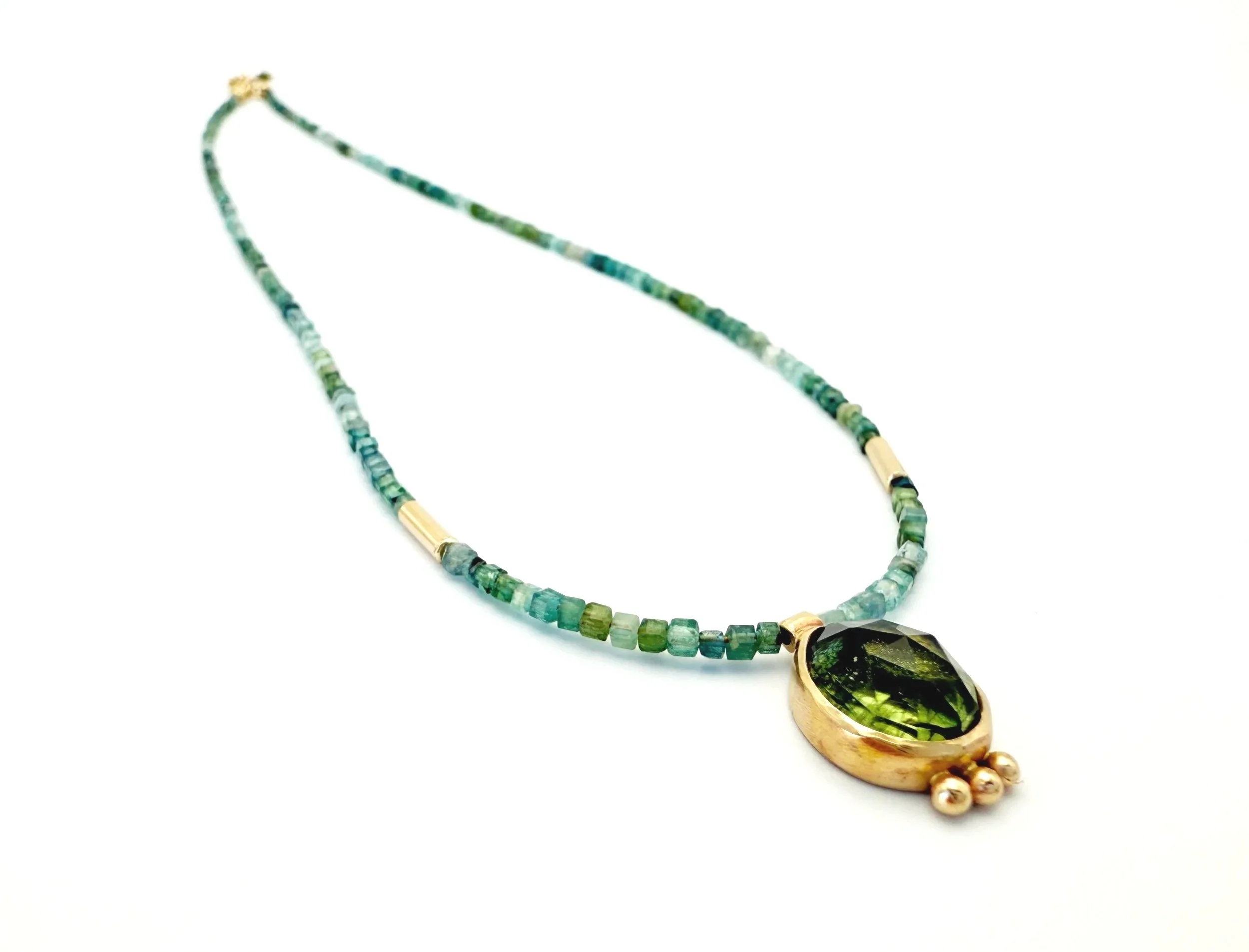 teardrop shaped ludwigite peridot pendant with blue green tourmaline beads in 14k gold