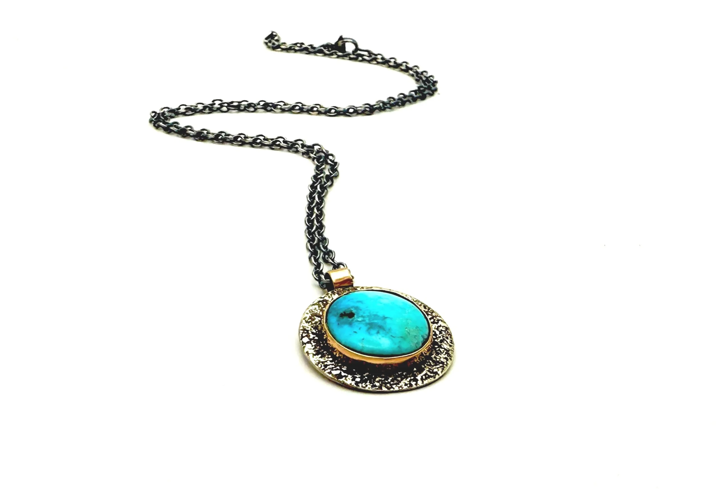 gold bezel set turquoise stone in 14k solid gold and oxidized silver