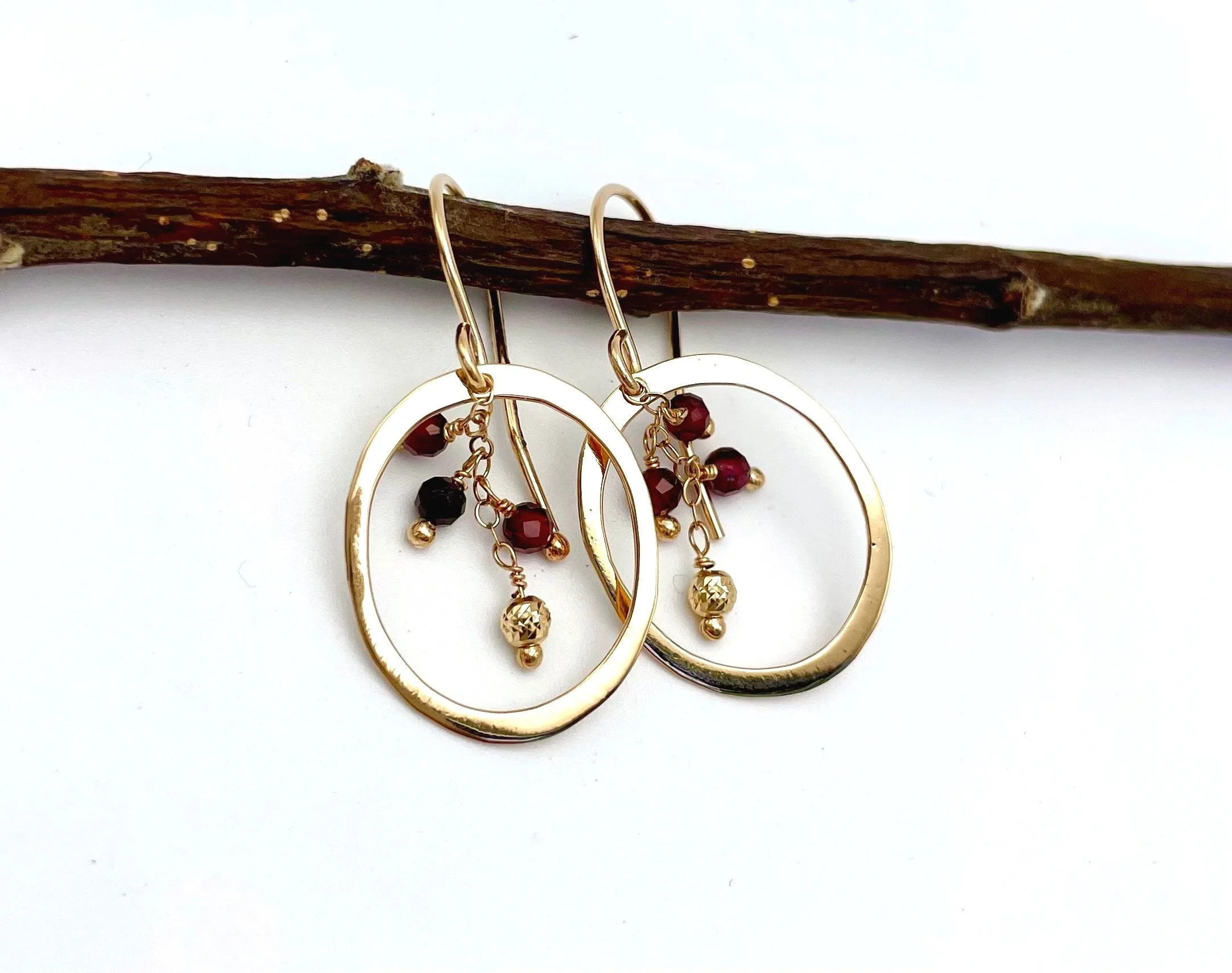 solid gold hoops with dangling garnet gemstones 14k