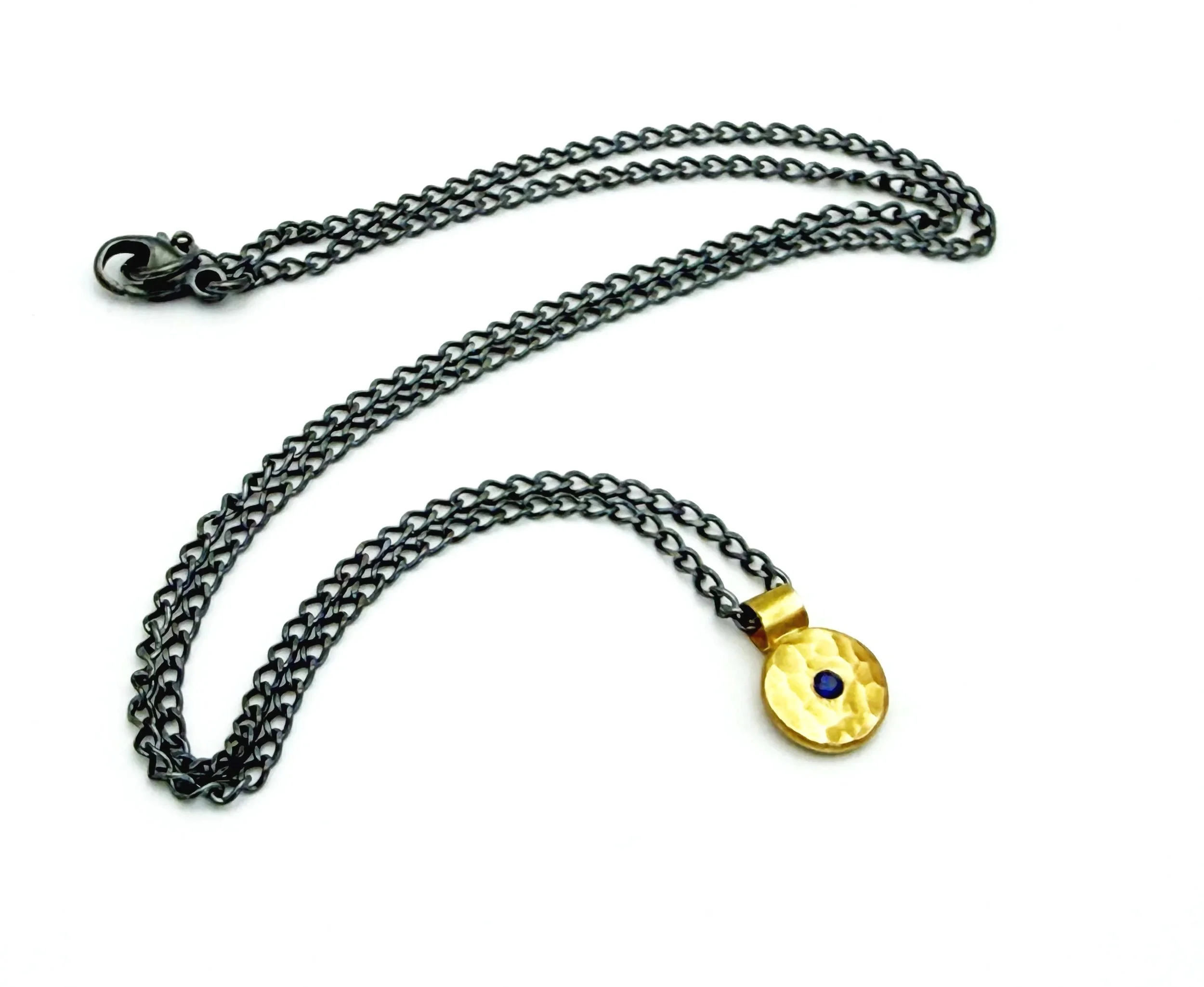 Full length of the 18k gold disc necklace on an oxidized silver chain, on white