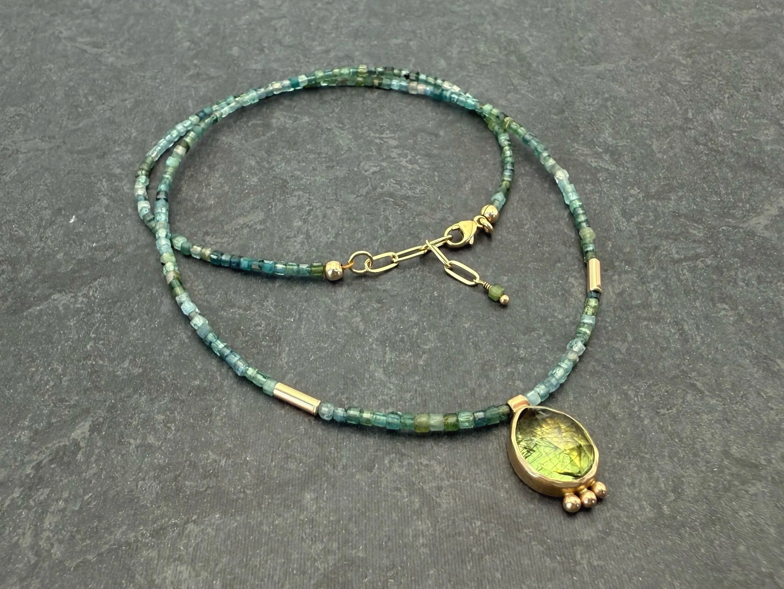 blue green tourmaline strand with peridot pendant in 14k solid gold