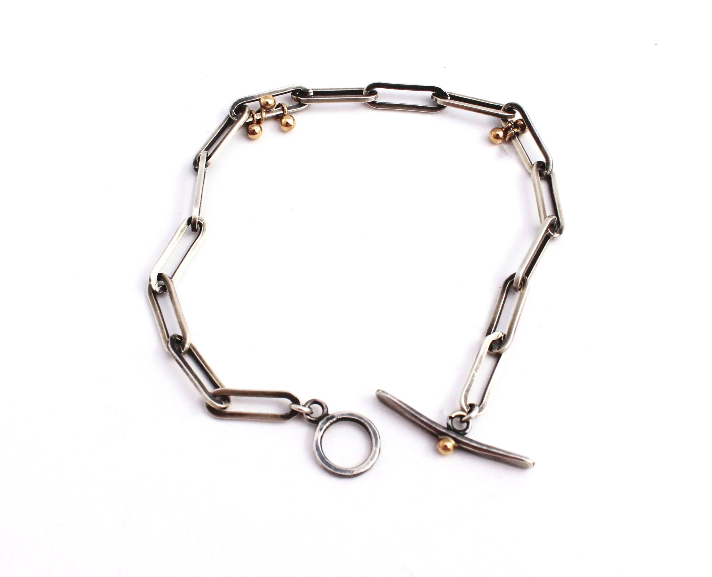 silver paperclip bracelet with 14k gold accents