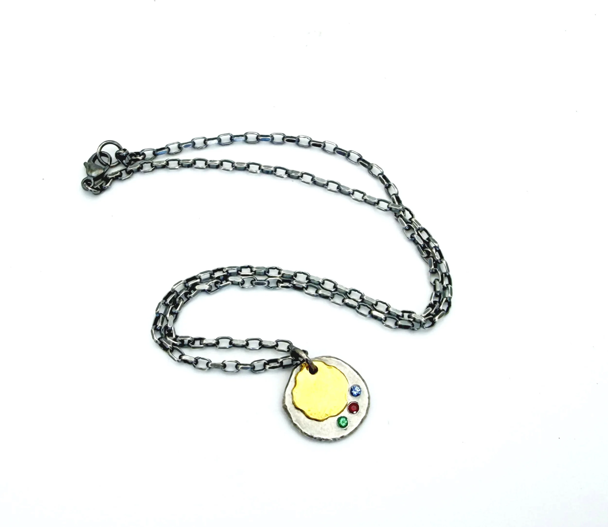 Full length of the oxidized silver birthstone disc necklace, on white
