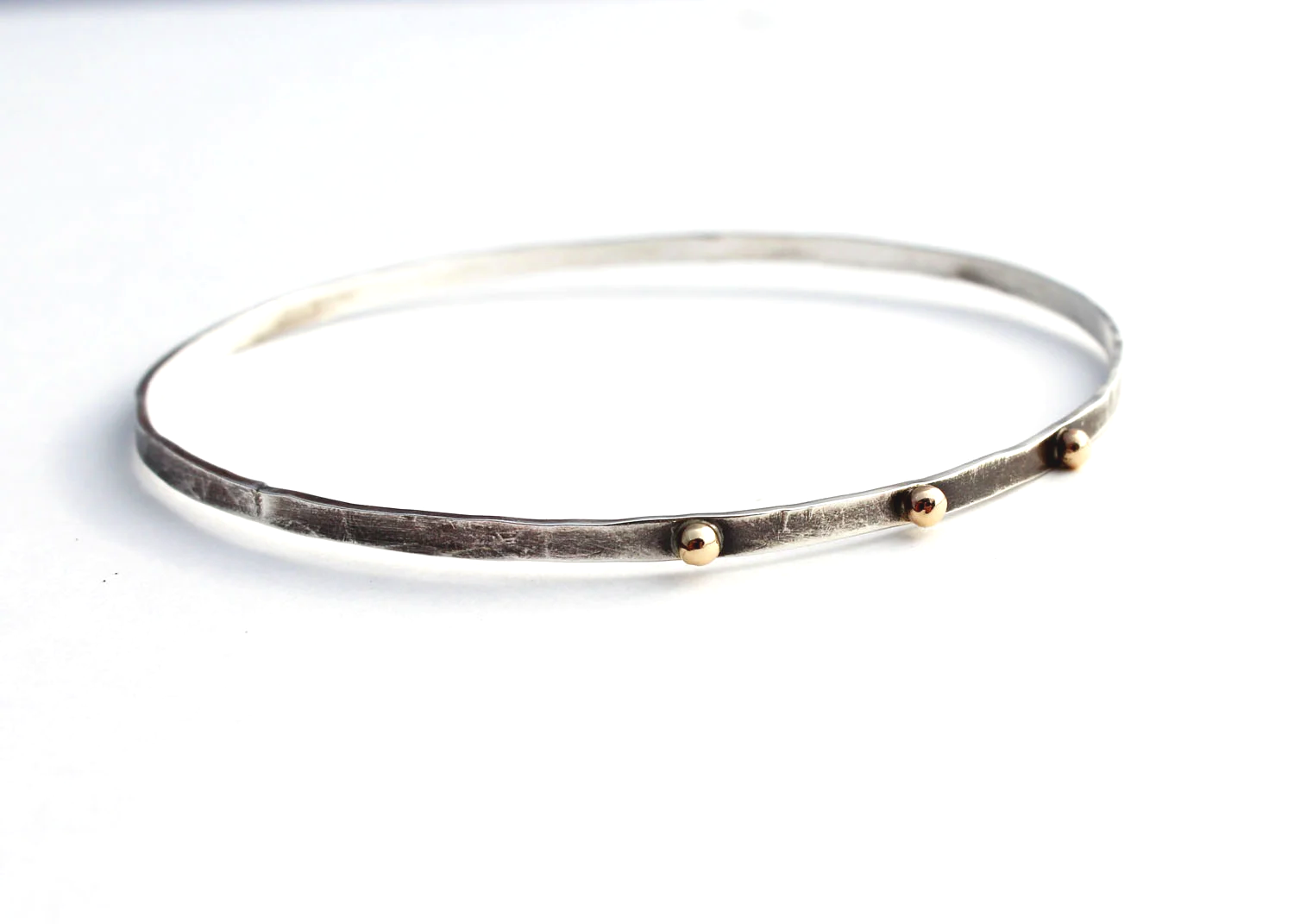 unique darkened silver bangle bracelet with gold