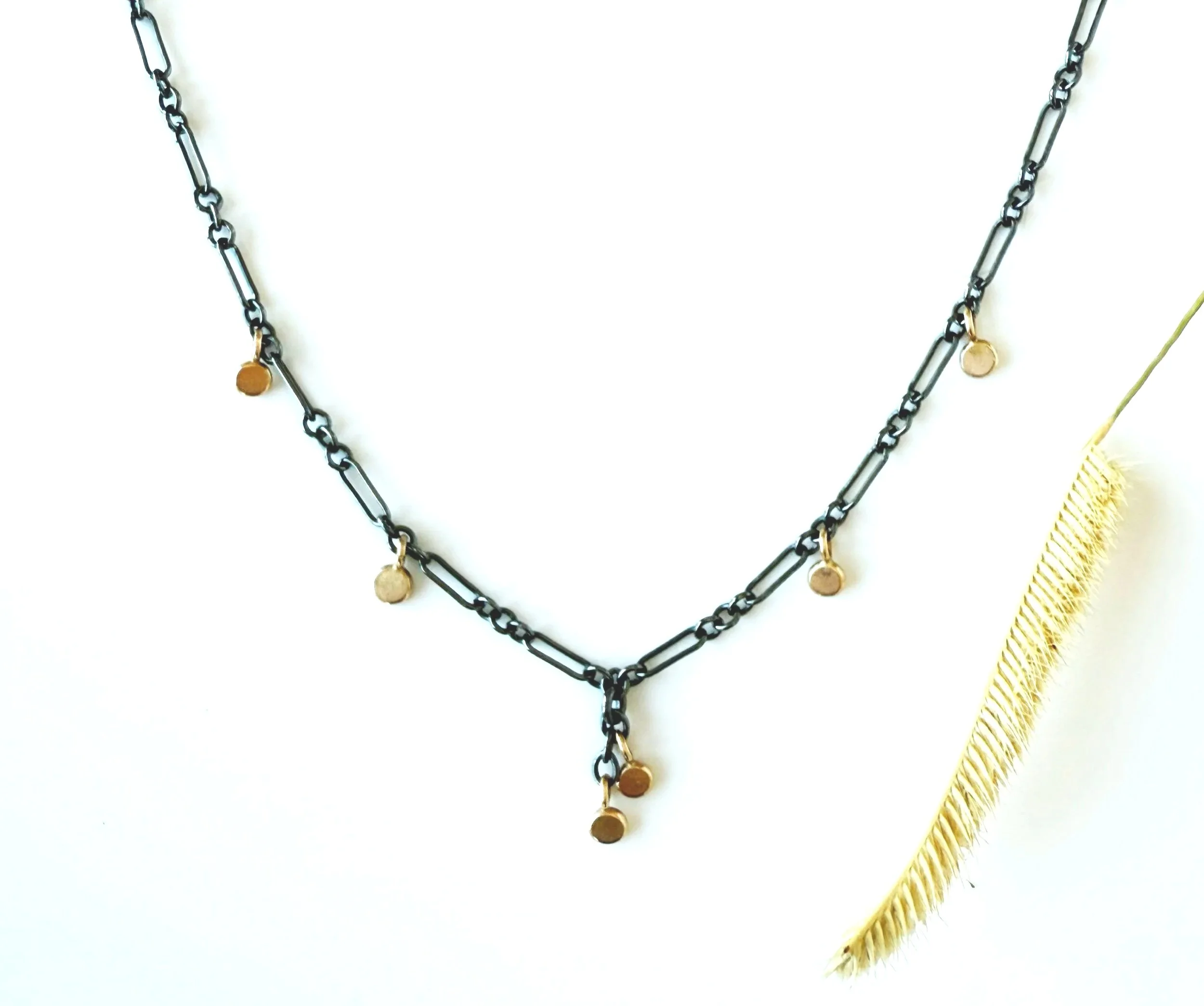 multi gold disc necklace on oxidized silver chain