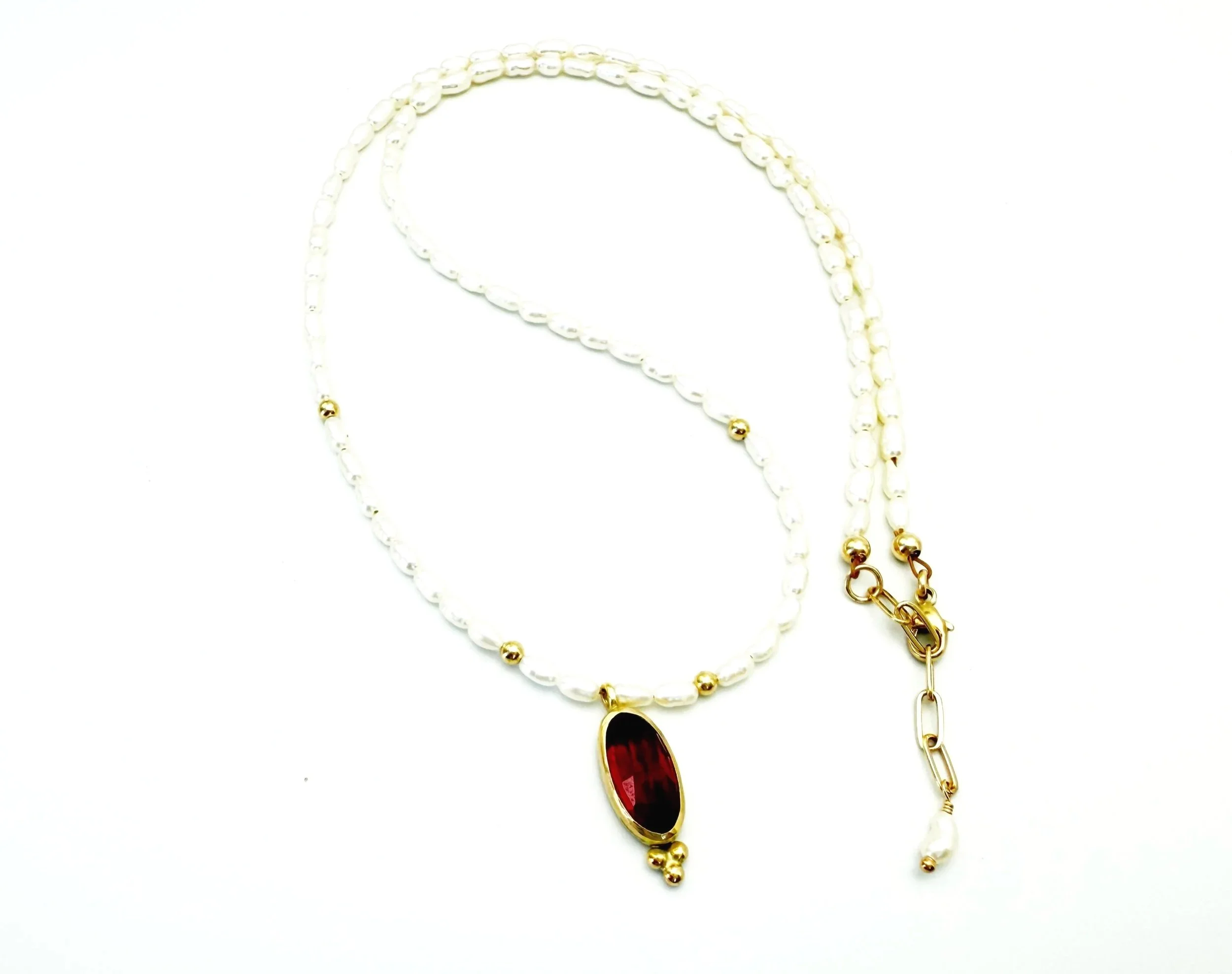 oval bezel set garnet pendant in 14k gold with pearls