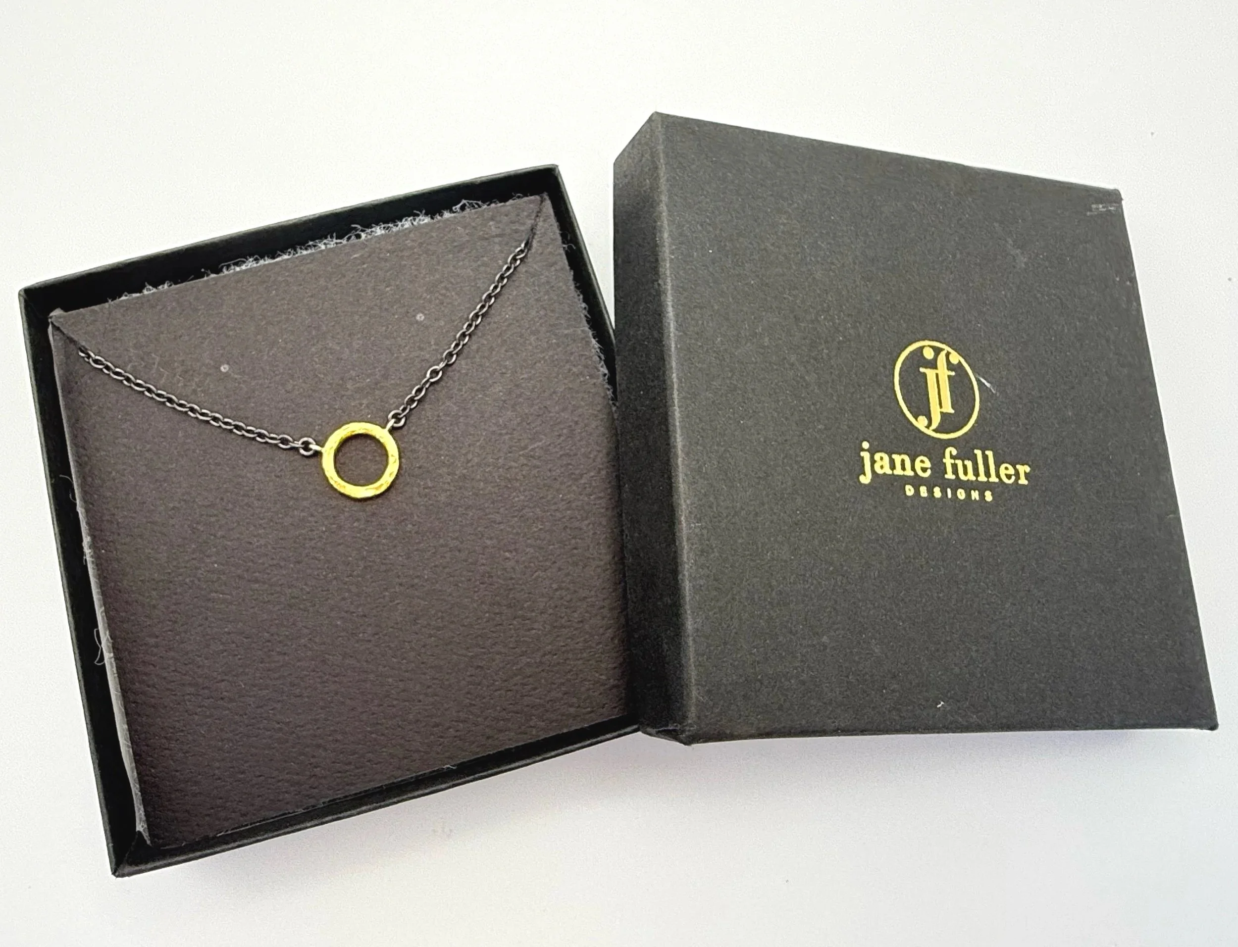 hammered 24k gold circle pendant with oxidized silver chain
