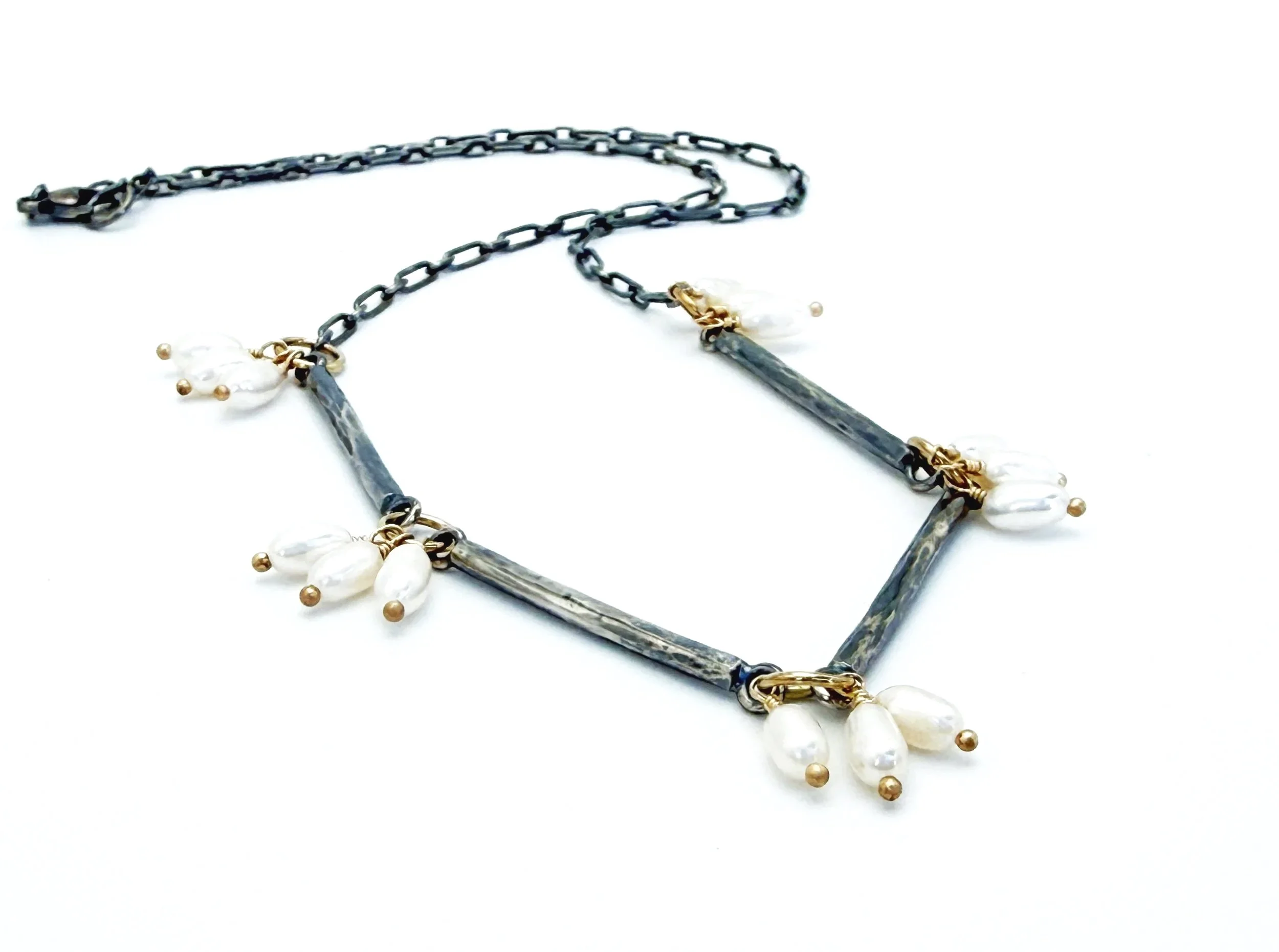 Freshwater pearl necklace with hammered oxidized silver bars and 14k gold links, on white
