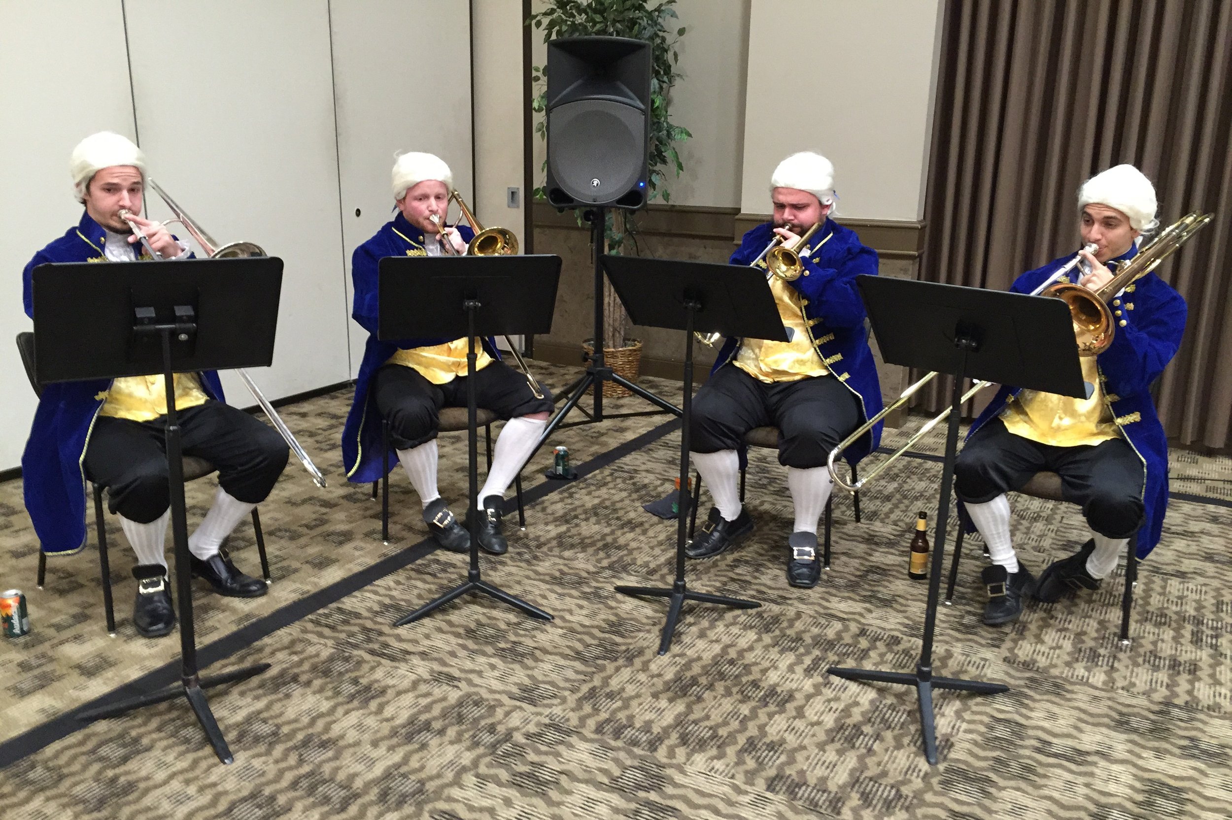 UNT College of Music Trombone quartet dressed in period costume and powdered wigs perform Moravian brass music from the American Colonies during pre-dinner reception.